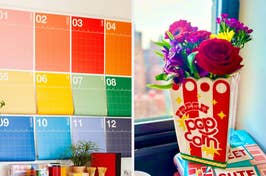 A colorful wall planner on the left, and a vibrant bouquet in a popcorn container on a windowsill on the right