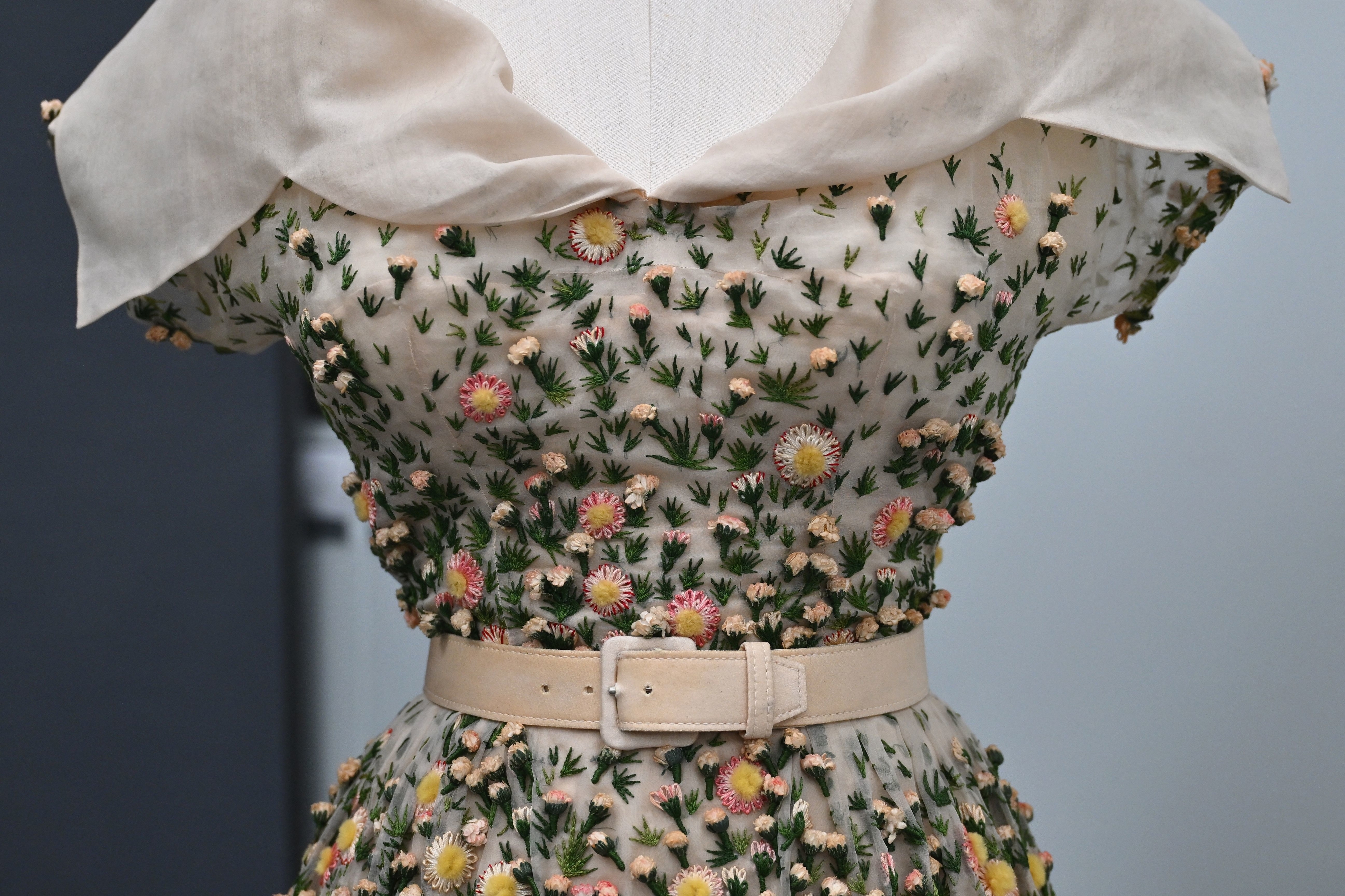 Midsection of a printed dress with a belted waist, showing detail of the garment&#x27;s design and texture
