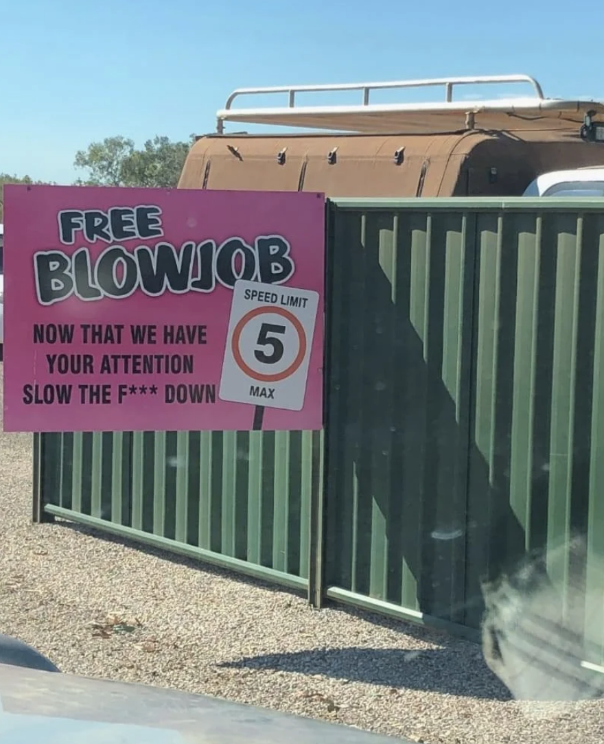 Sign humorously advertises a &quot;FREE BLOWJOB&quot; to capture attention for a 5 mph speed limit reminder