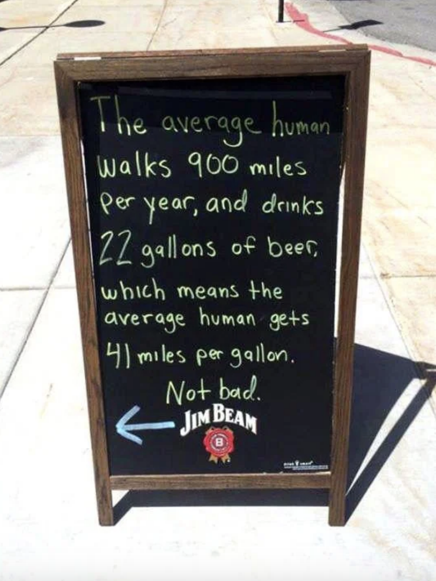 Chalkboard sign with humorous comparison of walking miles to beer consumption, crediting Jim Beam