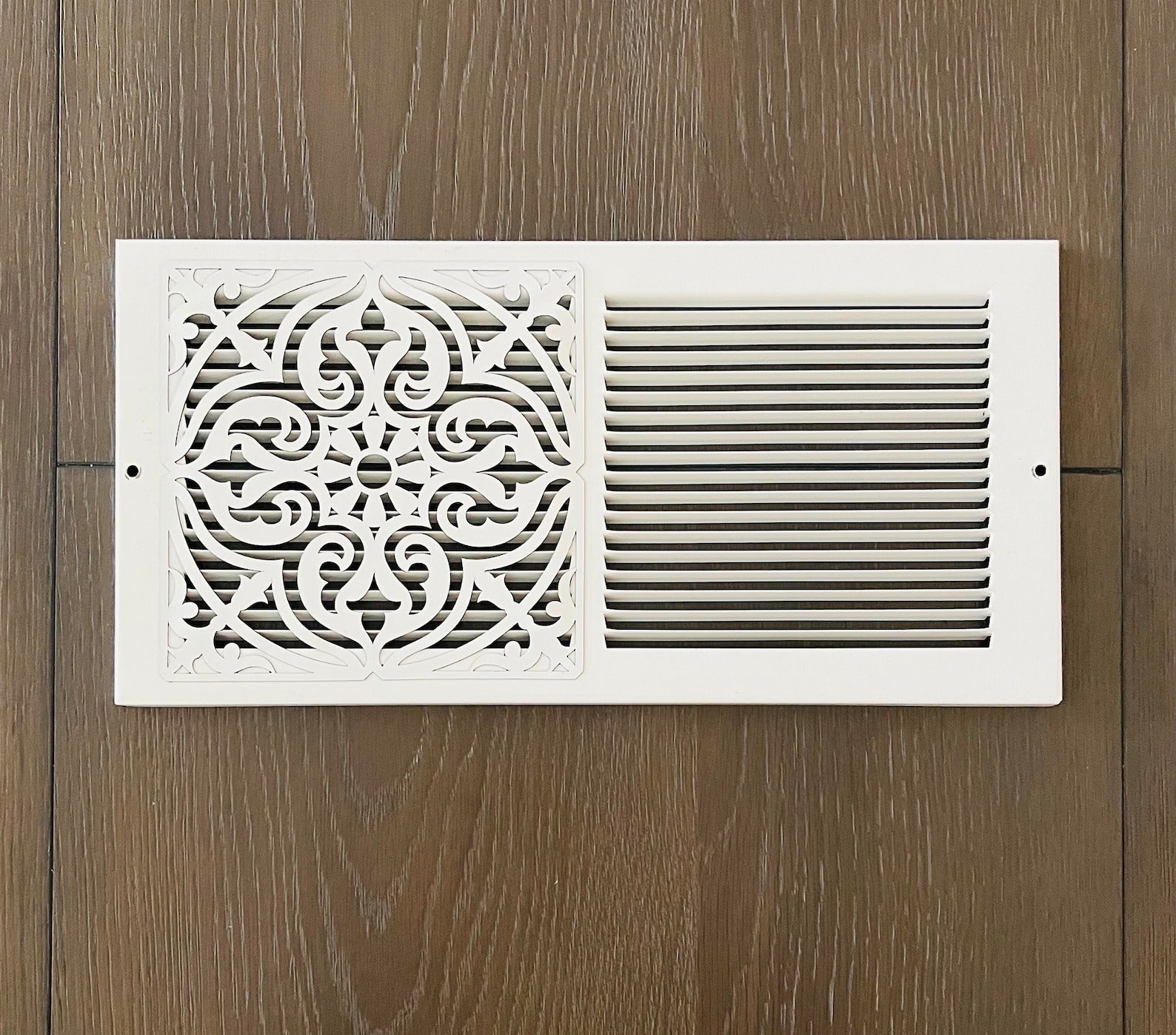 Decorative vent cover next to a standard one on wooden floor for comparison