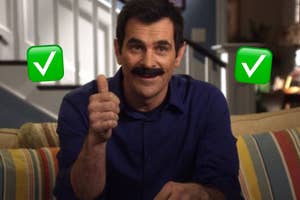 Tom Selleck in a blue shirt, giving a thumbs up, sitting on a couch with striped cushions. Two green checkmarks are superimposed