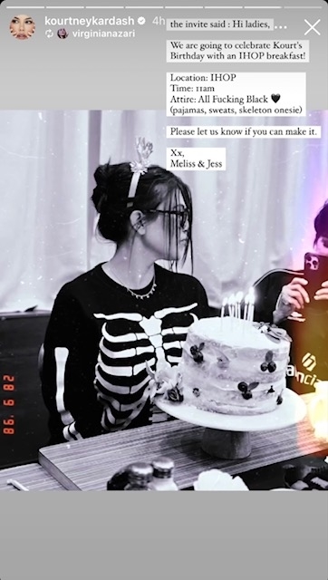 Kourtney Kardashian in a skeleton onesie at a birthday event with cake and candles, indoors