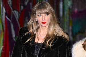 Taylor Swift wearing a black fur coat, with red lipstick at an event