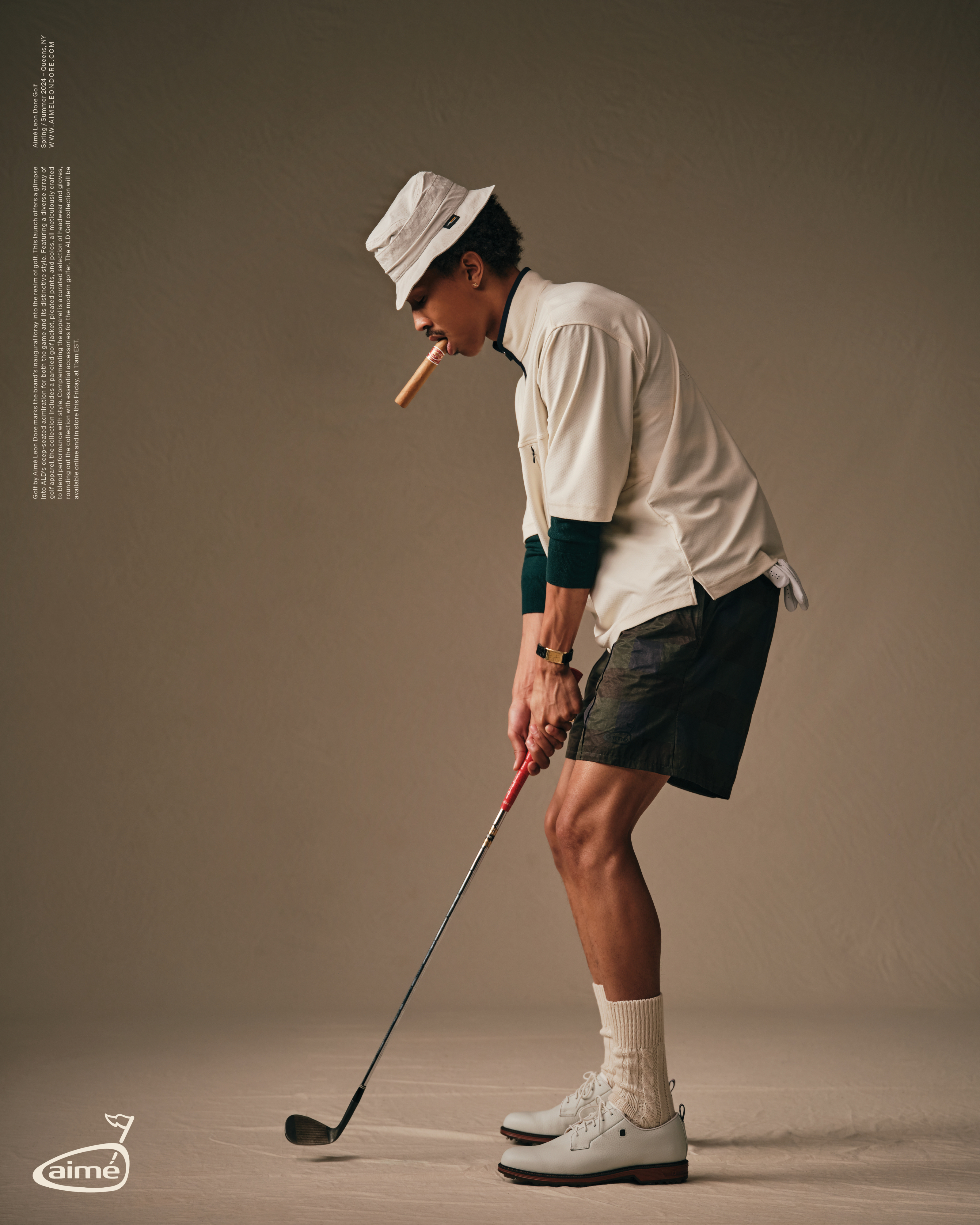 Person in sporty outfit with a golf club, paired with a cap and high-top shoes