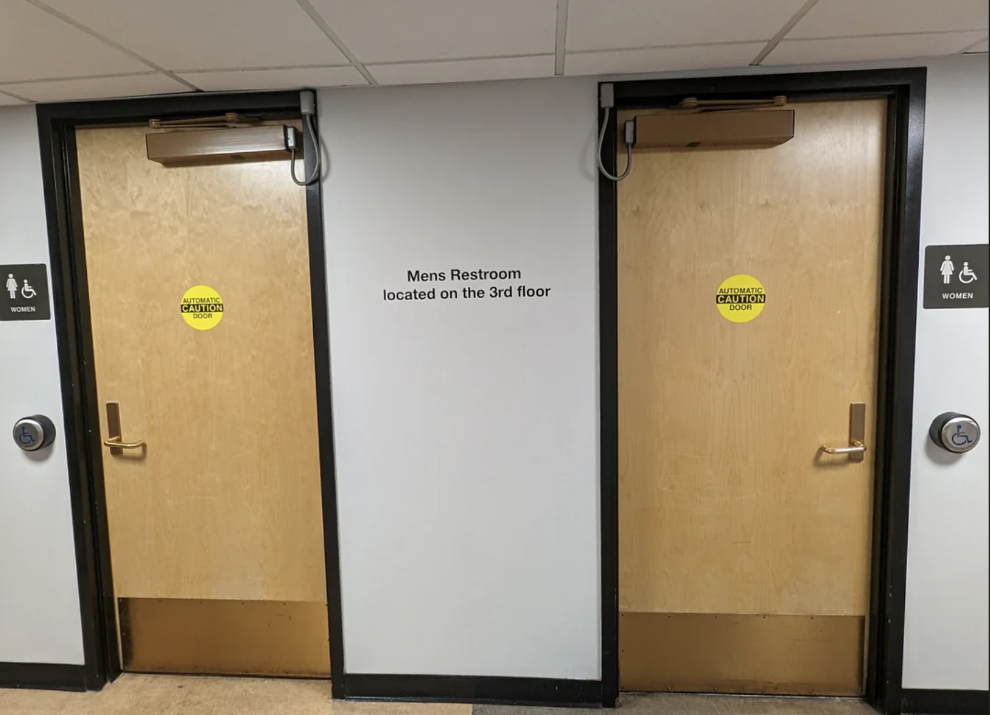 Two restroom doors with signs indicating the men&#x27;s restroom is on the 3rd floor