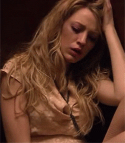 Woman looks distressed while running her hand through her hair