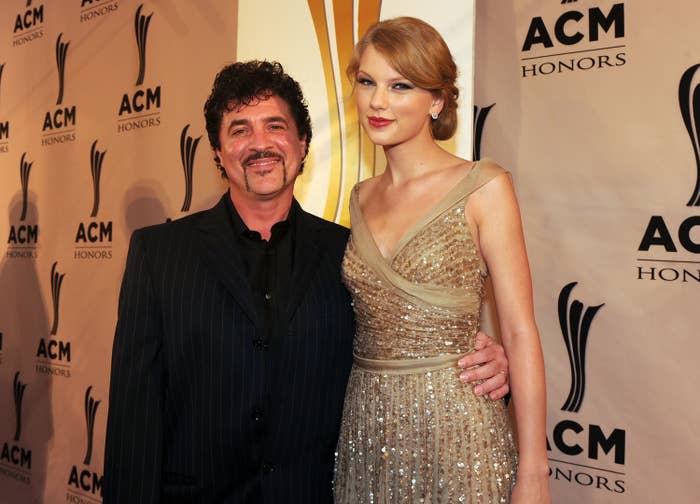 Scott Borchetta and Taylor Swift at an event, Swift in a sequined dress, both smiling