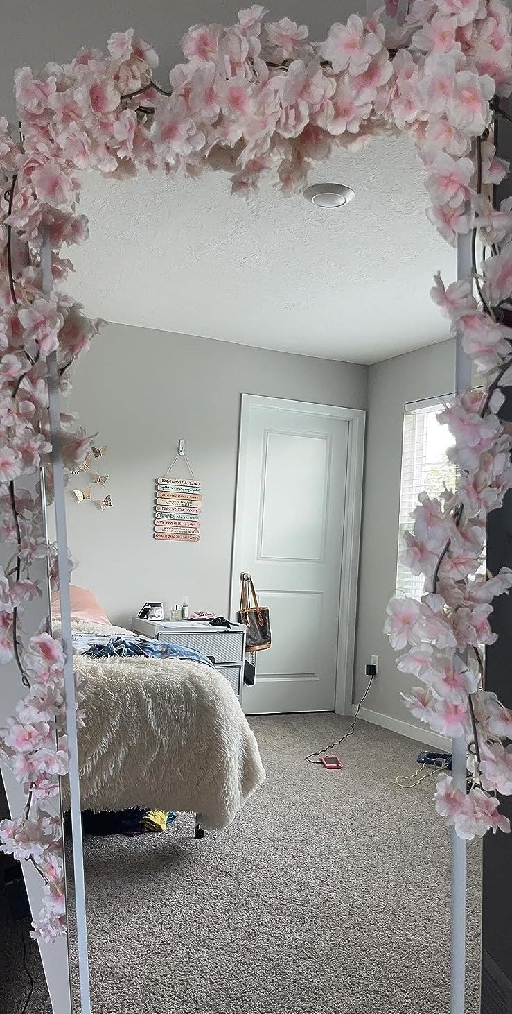 Floral archway in a bedroom with a bed and decor visible, promoting home decoration options
