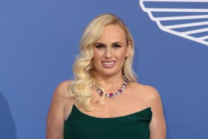 Rebel Wilson in a one-shoulder green dress with a statement necklace