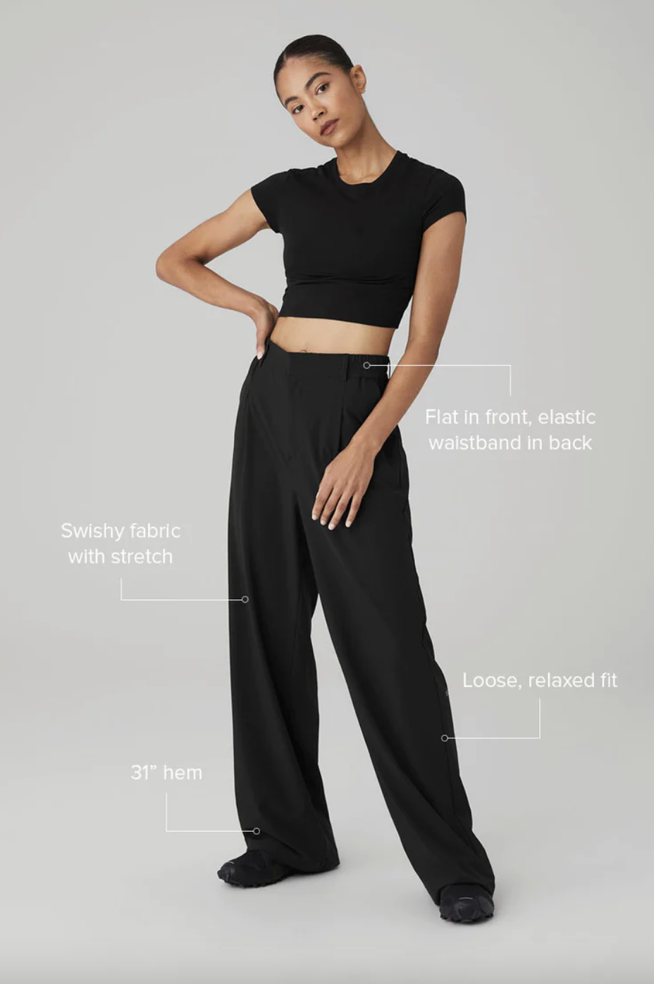 Woman modeling black crop top and wide-leg pants with descriptive text on fit and design