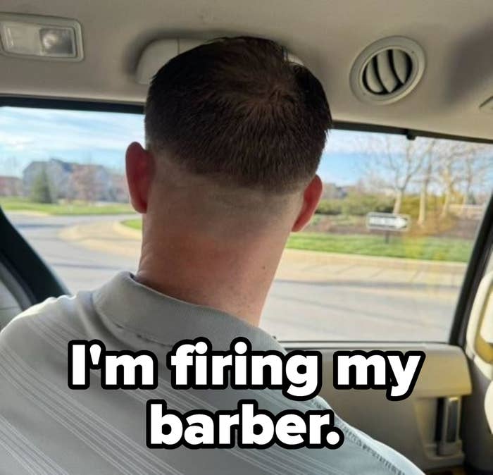 Man in a vehicle looking out of the front windshield with a short haircut