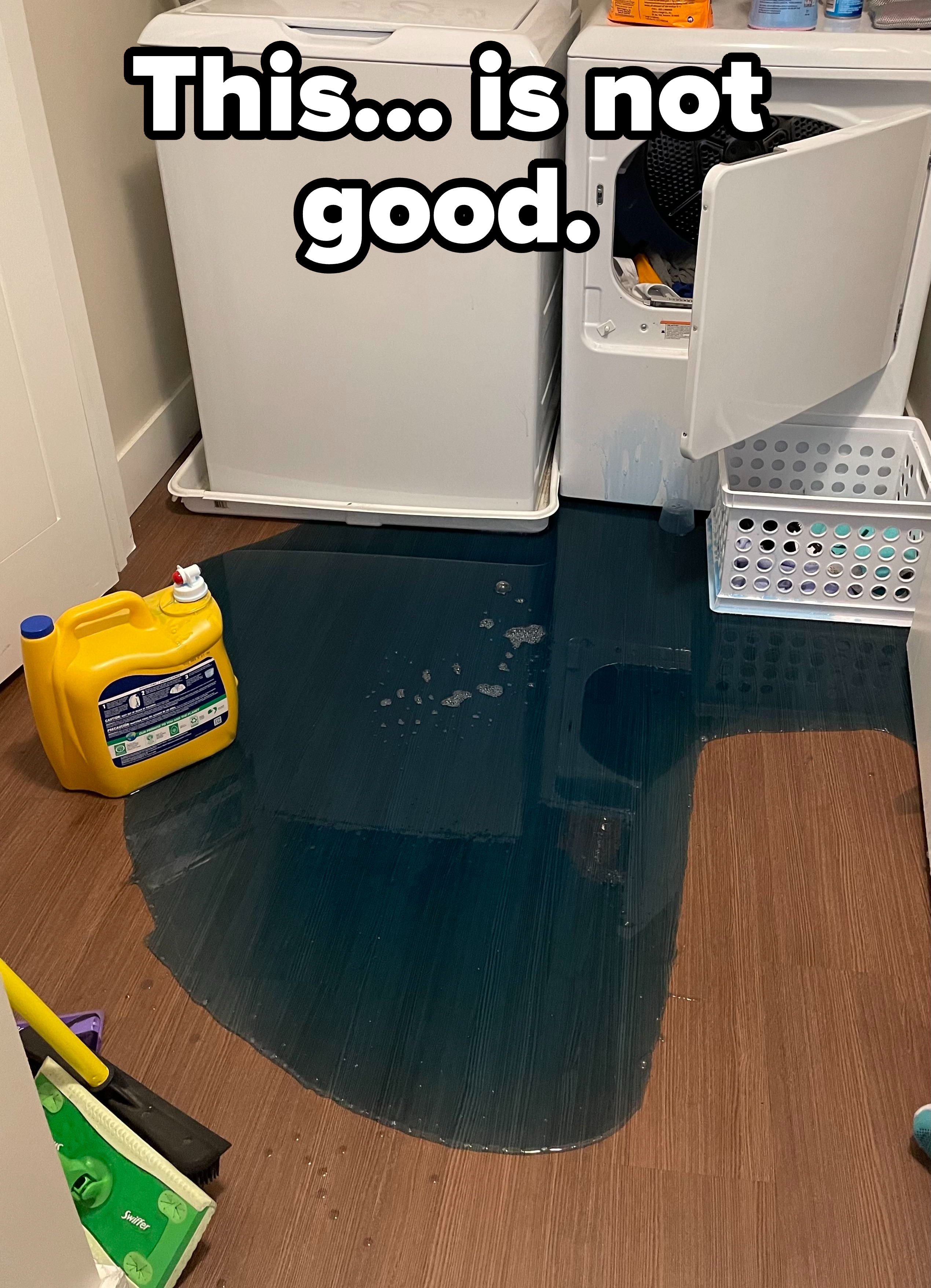 Washing machine leaks on floor in a utility room; laundry items and detergent nearby