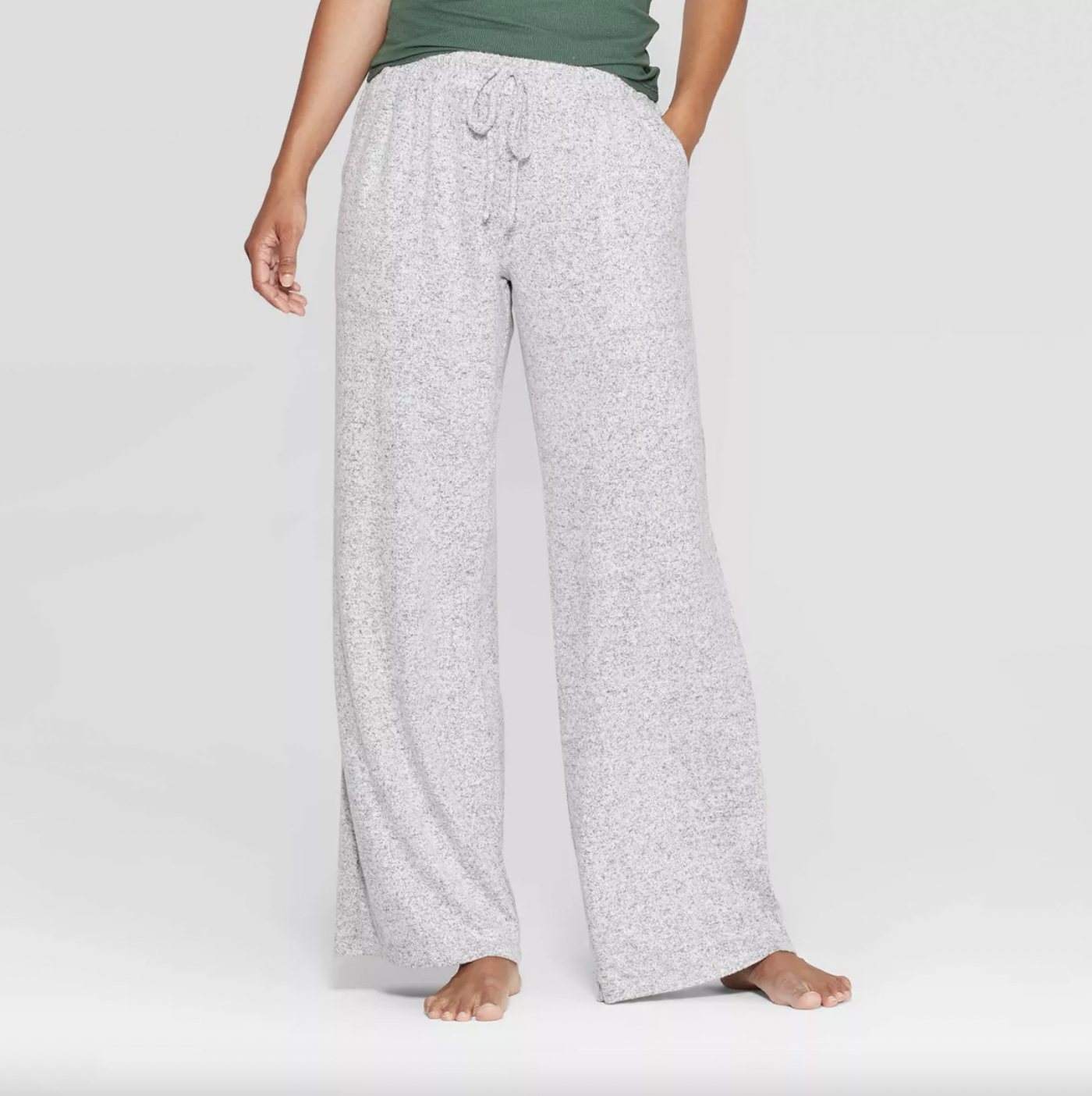Person wearing gray speckled lounge pants with drawstring and a green top