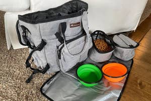 Pet travel bag set with various compartments and collapsible bowls