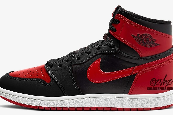 A single Air Jordan 1 sneaker with black overlays, red toe box, and side swoosh, white midsole