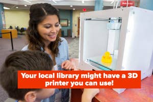 A child watches as an adult assists with a 3D printer at a library
