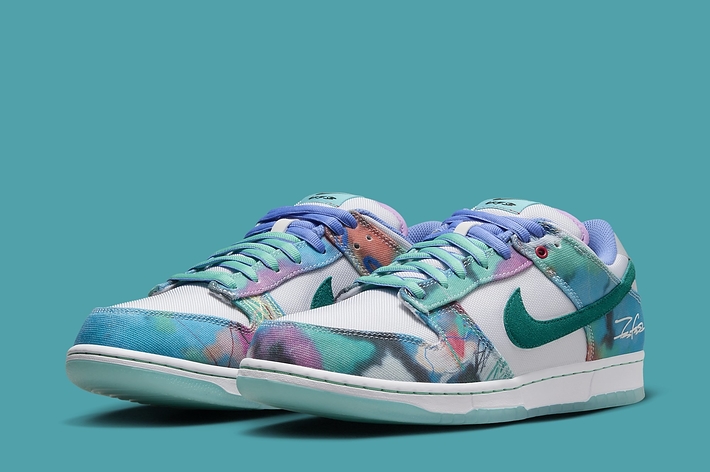 Nike sneakers featuring a pastel-toned, floral pattern with swoosh logo on teal background