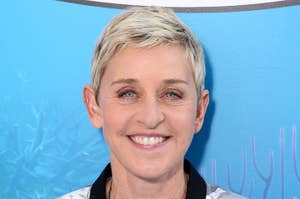 Ellen DeGeneres smiling in a jacket and shirt, with a blue backdrop