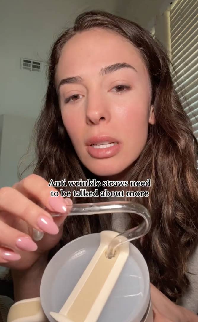 Woman holding a wrinkle-prevention straw, text reads &quot;Anti wrinkle straws need to be talked about more&quot;
