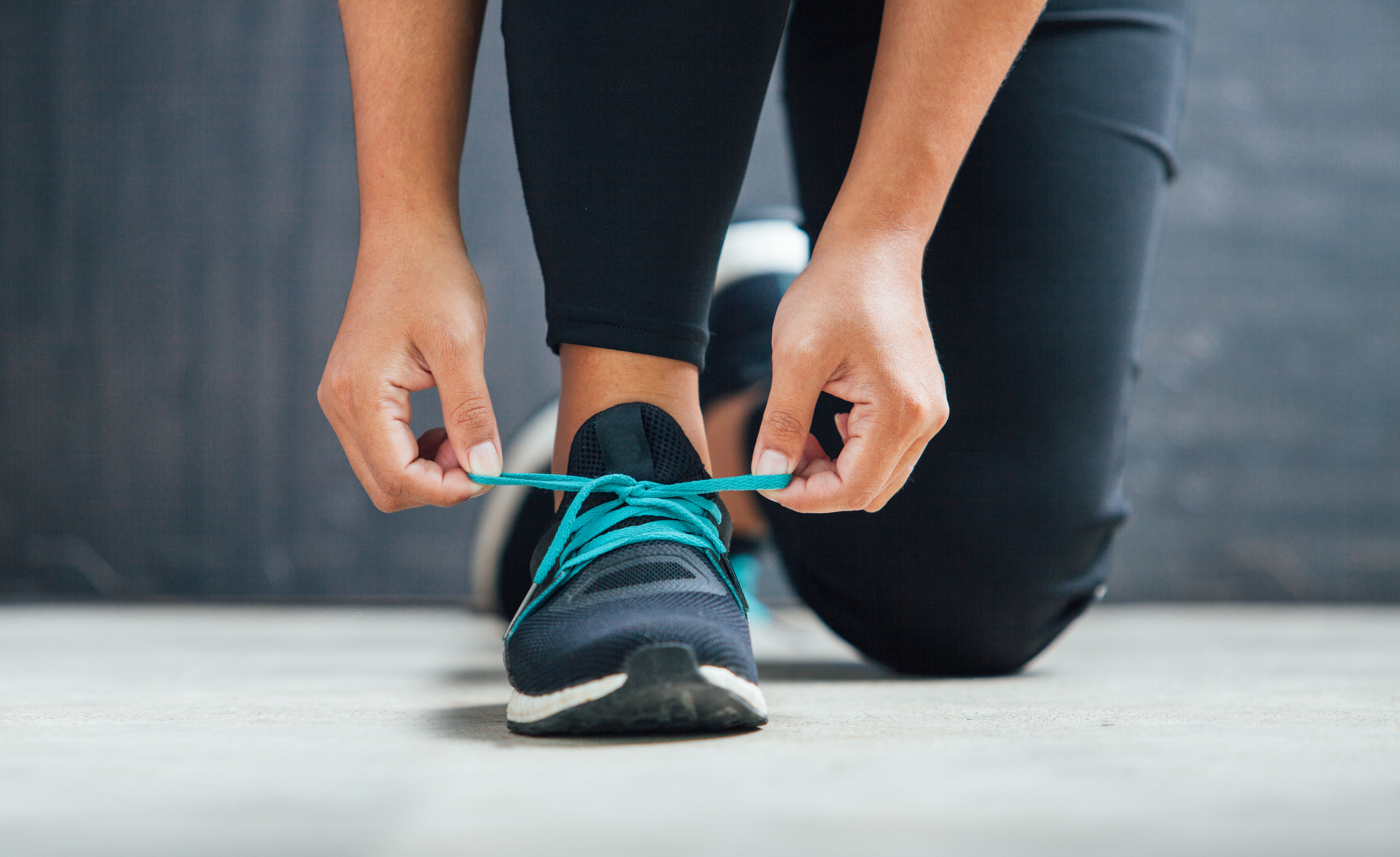 Close-up of a person tying the laces of a running shoe