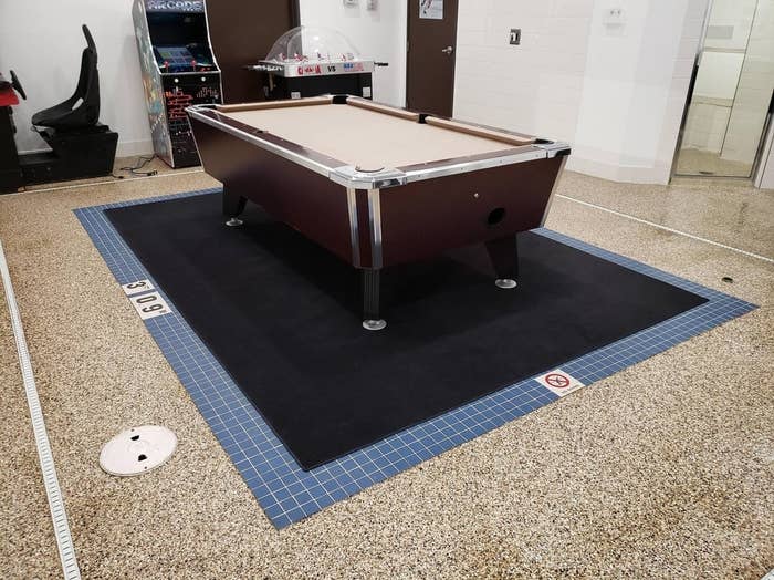 Pool table with surrounding tactile paving for visually impaired individuals