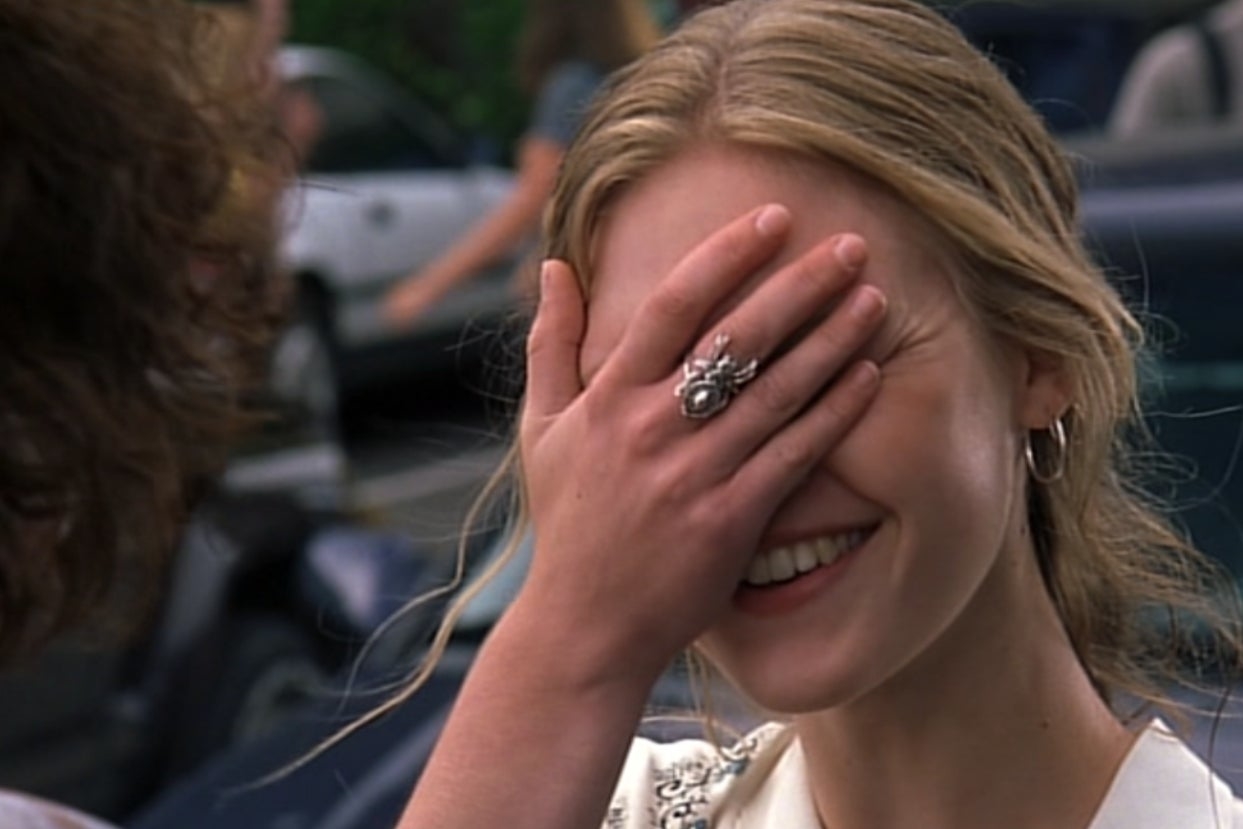On the left, Kat from 10 Things I Hate About you smiling and covering her eyes with her hand