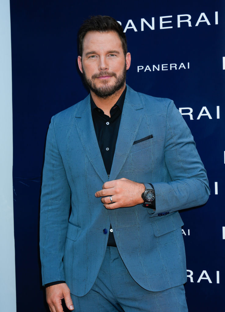 Chris Pratt wearing a blue suit and watch at an event with Panerai backdrop