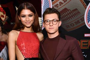 Zendaya in a sequined dress beside Tom Holland in a suit at an event