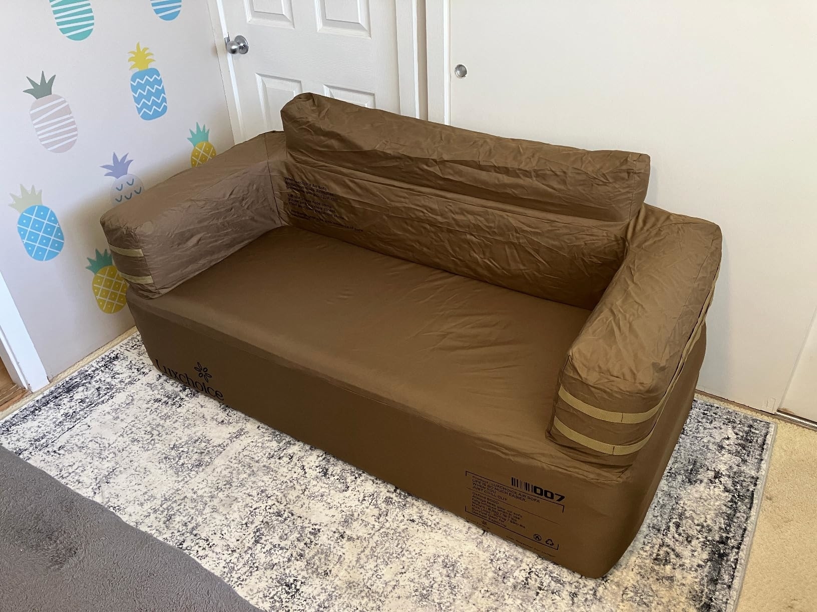 Inflatable couch in a room with decorative wall and patterned rug, suitable for casual home furnishing