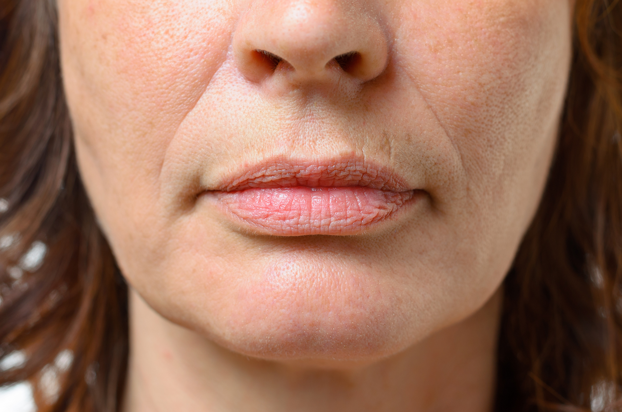 Close-up of an unidentified person&#x27;s lower face, showing nose and lips.
