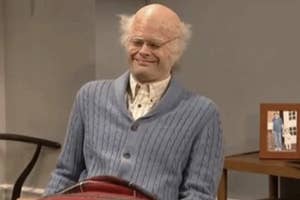 Bill Hader as an elderly man in a skit, wearing a sweater, seated with a slight grin