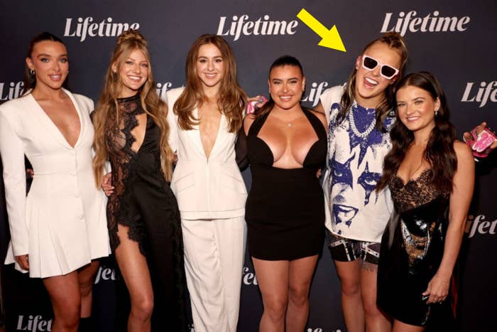 Five women successful  stylish attire posing unneurotic  astatine  a Lifetime event