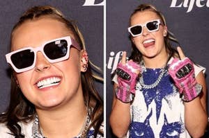 Jojo Siwa smiling in pink glasses, denim jacket, fingers up in a peace sign, wearing a necklace and fingerless gloves