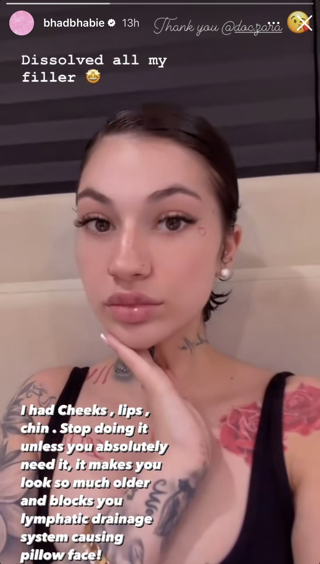 Photo of Bhad Bhabie touching her face, wearing a black top, with facial piercings and tattoos. Text overlays express gratitude
