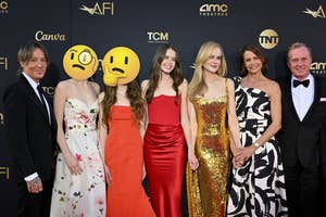 Group of seven people posing together, two wear sequin gowns, others in formal attire. Faces obscured for privacy