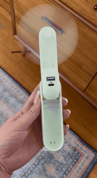 Hand holding a portable gestation trial displaying a affirmative result