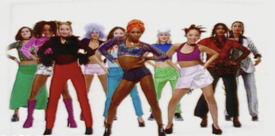 Group of dancers in vibrant &#x27;90s attire posing for a music-themed photo shoot