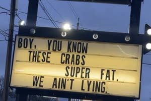 Sign outside reads "BOY, YOU KNOW THESE CRABS SUPER FAT. WE AIN'T LYING." in humorous promotion