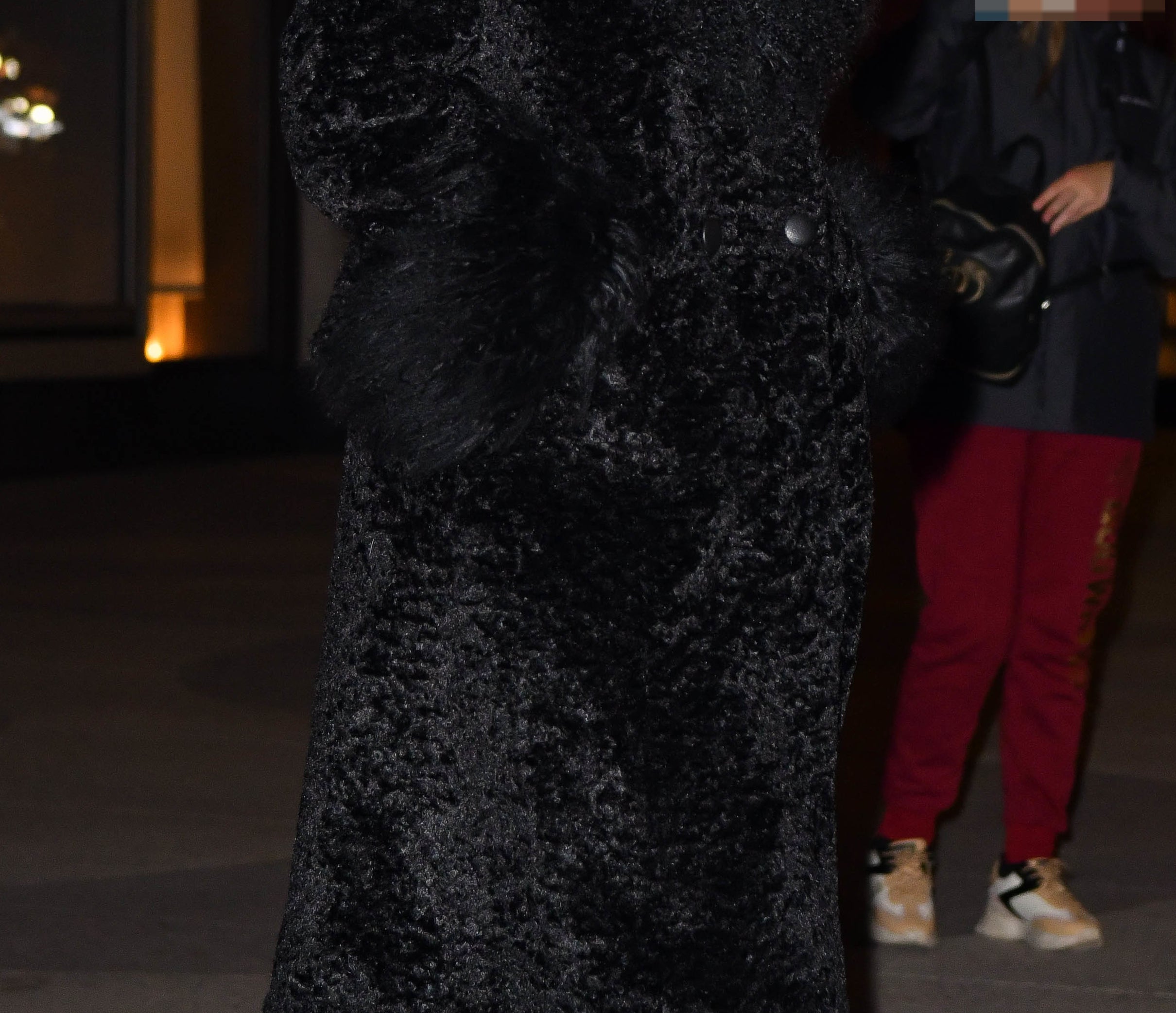 Taylor Swift in elegant black fur coat and heels