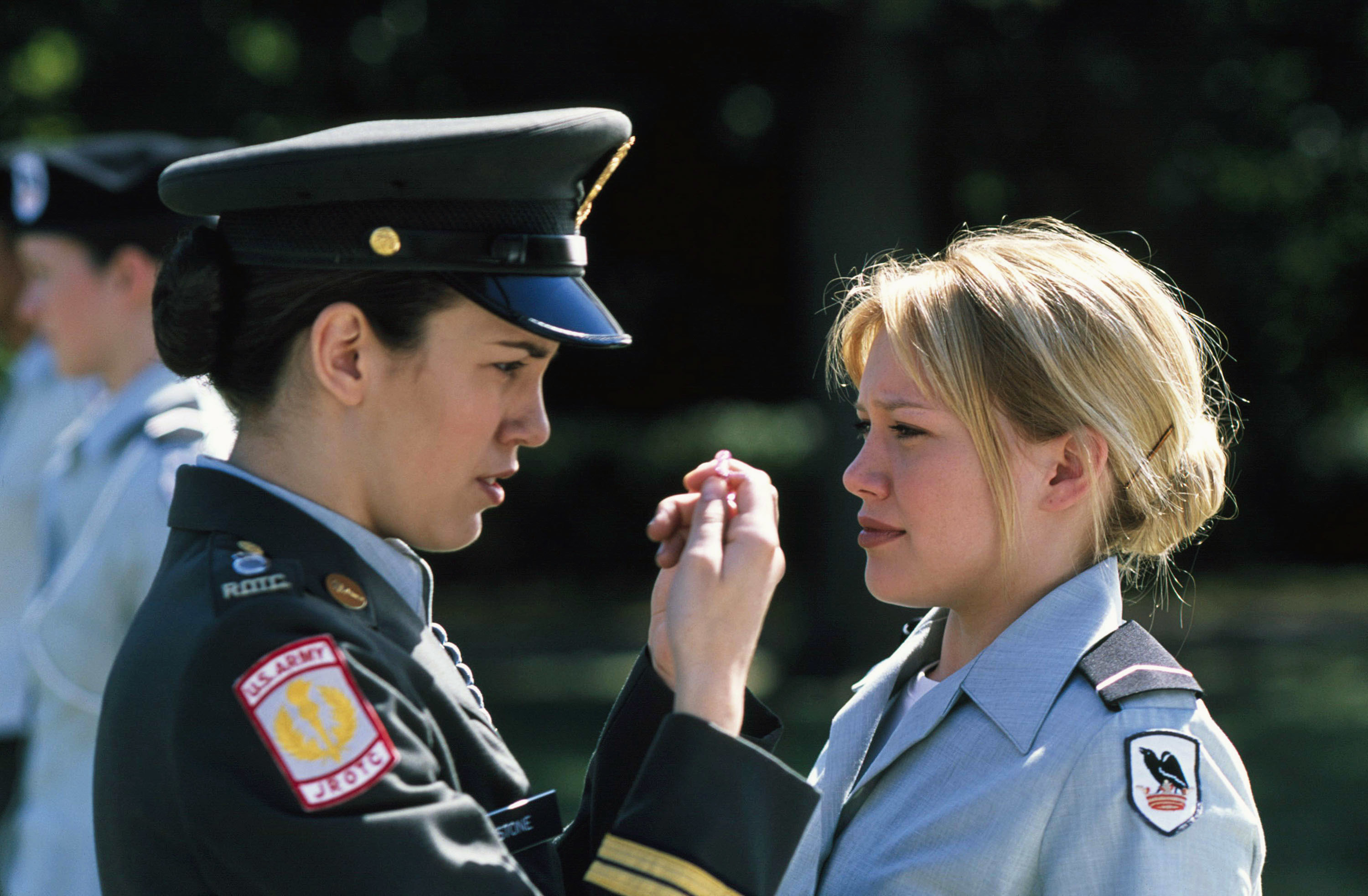 Two actors in military uniforms engage in a conversation in a film scene