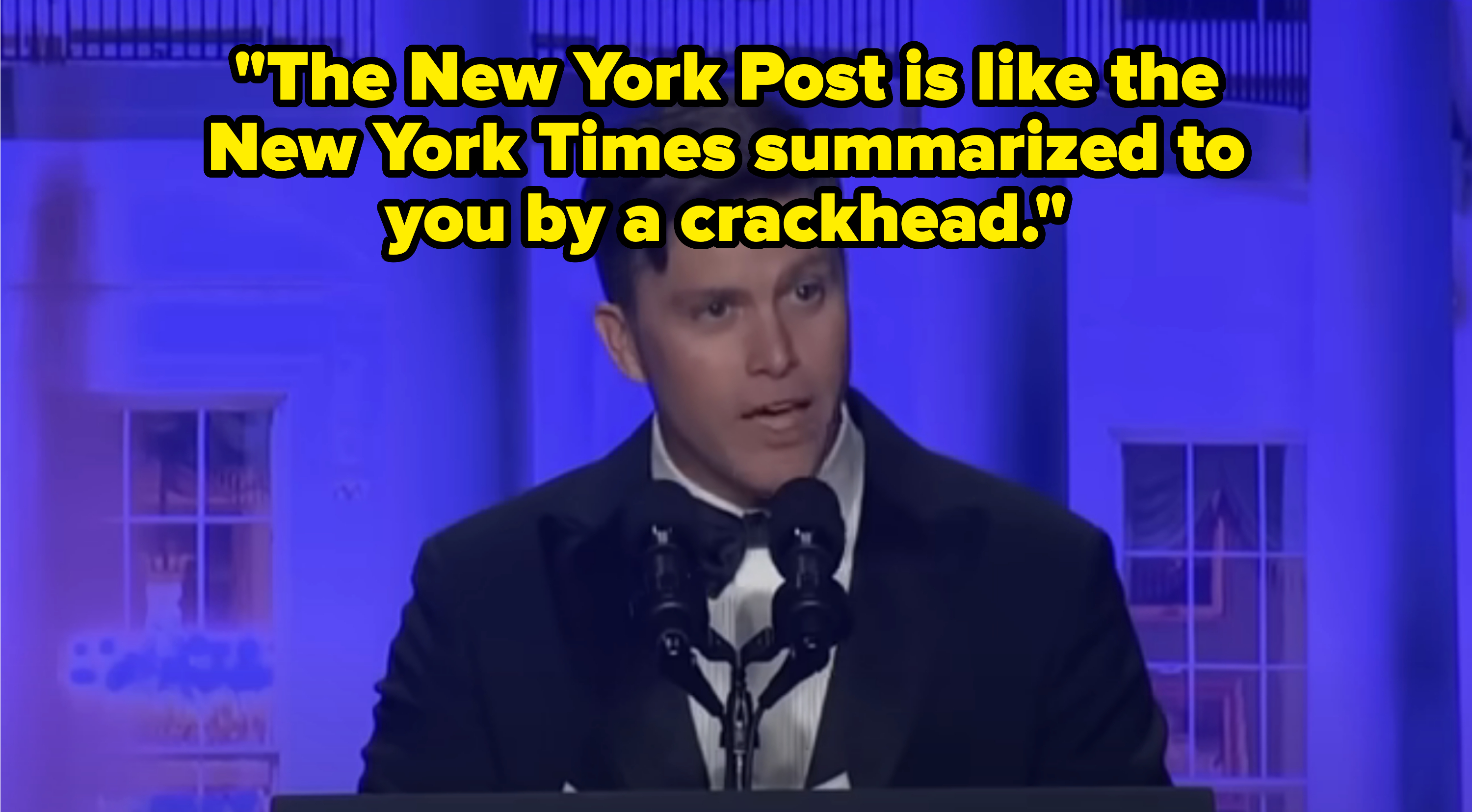 Closeup of Colin Jost onstage saying, &quot;The New York Post is like the New York Times summarized to you by a crackhead&quot;