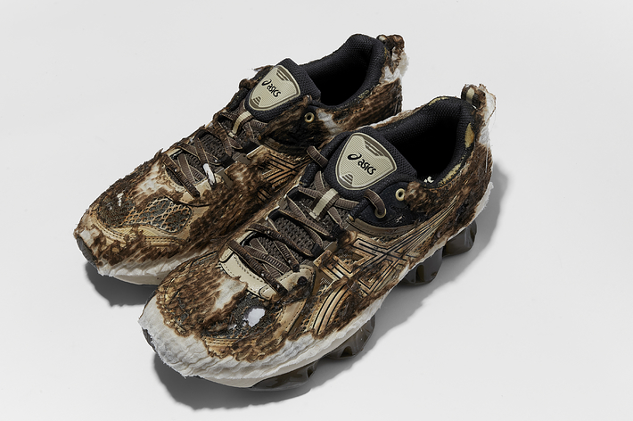 A pair of Asics sneakers with snake print design, shown from a top angle on a plain background