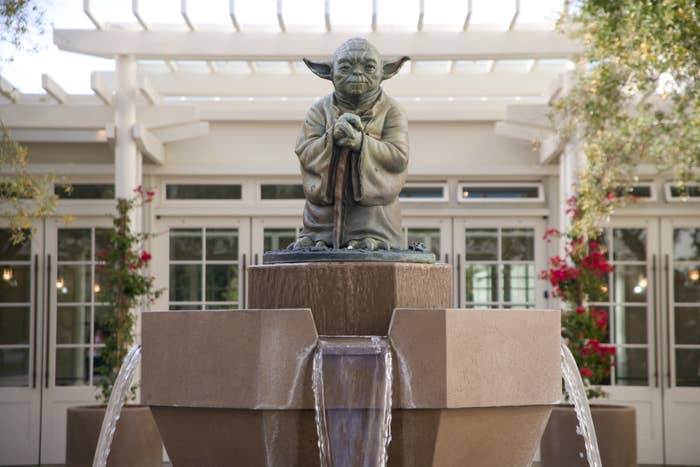 Statue of Yoda from Star Wars, positioned at the center of a fountain
