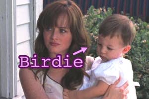 Rory Gilmore holding a baby that has an arrow pointing towards it with the word "Birdie."