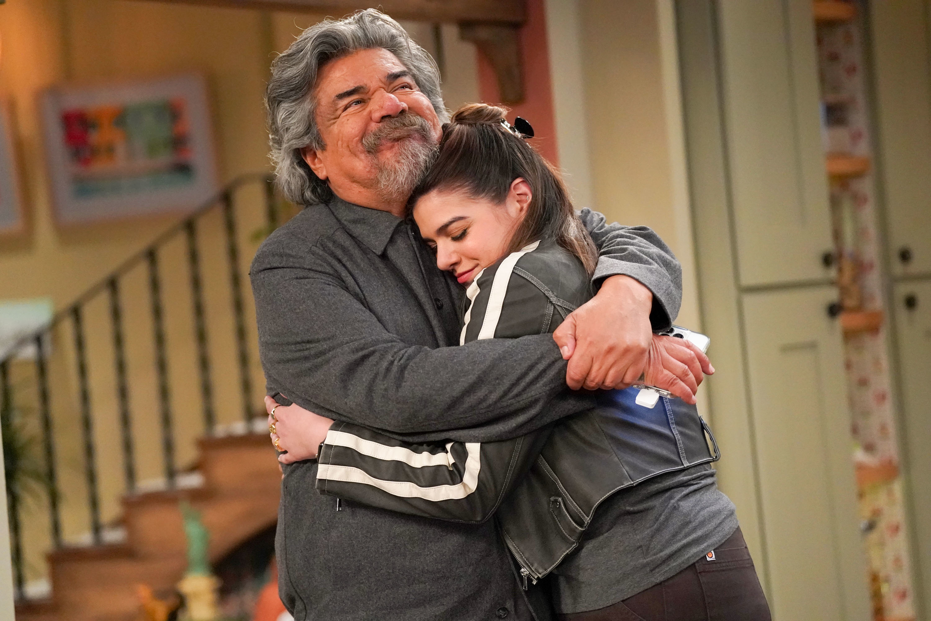 George Lopez and his on-screen granddaughter embrace warmly in a TV show scene