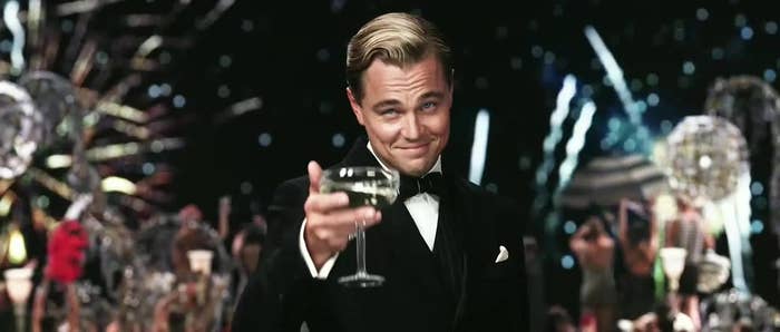 Leonardo DiCaprio as Jay Gatsby toasting with a champagne glass, in a black tuxedo, from &quot;The Great Gatsby&quot; film