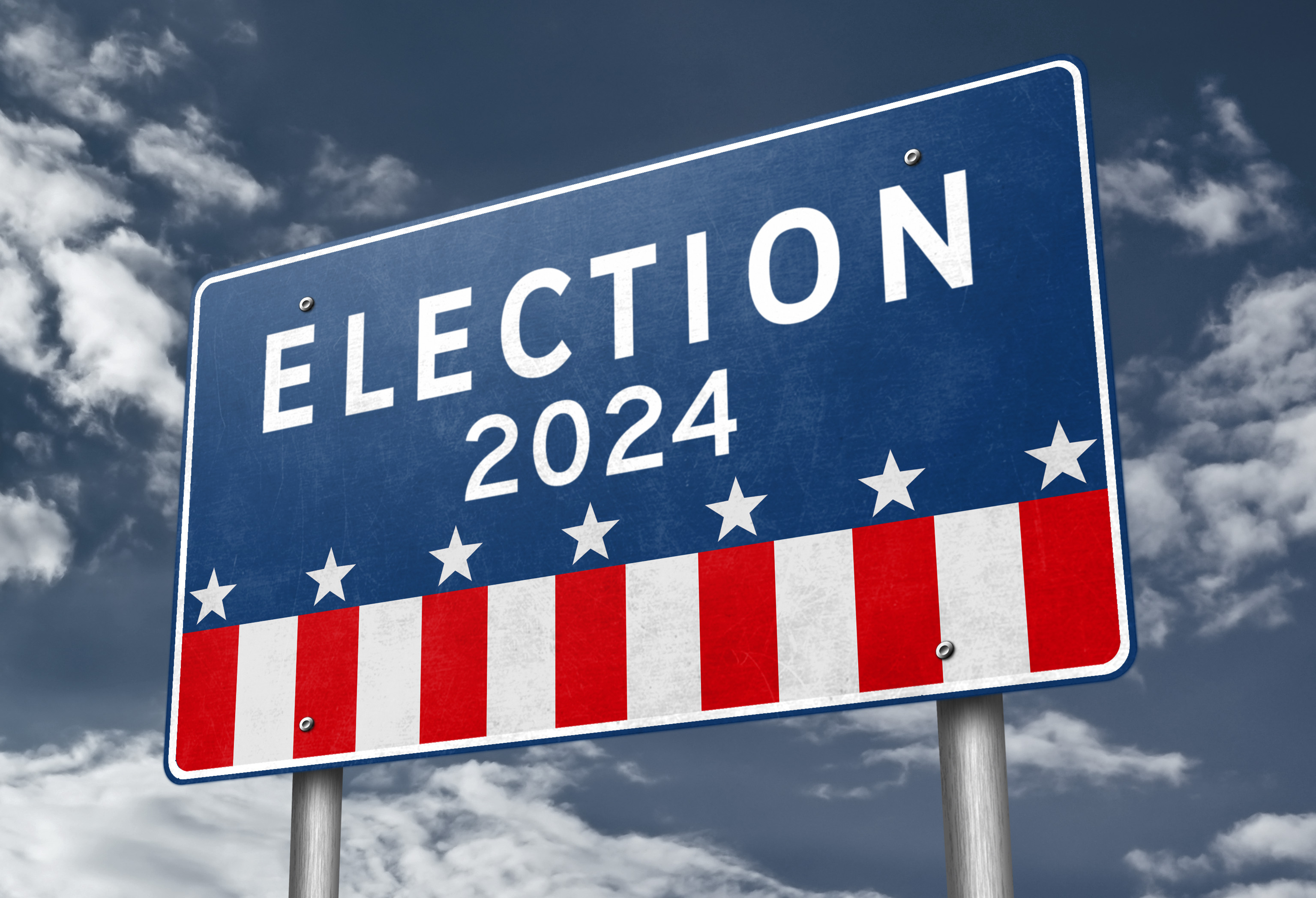 Sign reading &quot;ELECTION 2024&quot; with patriotic stars and stripes, against a cloudy sky