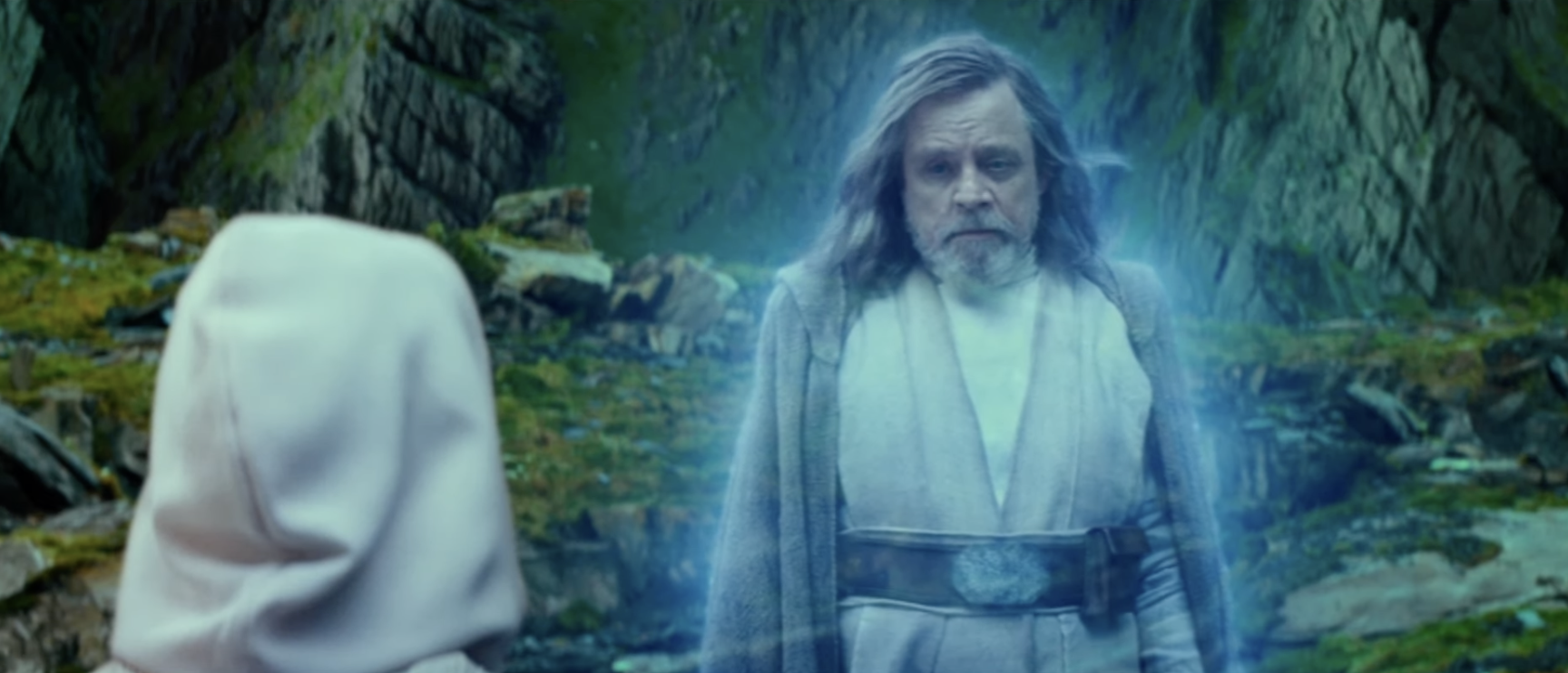 Character Luke Skywalker appears as a force ghost facing character Rey outdoors