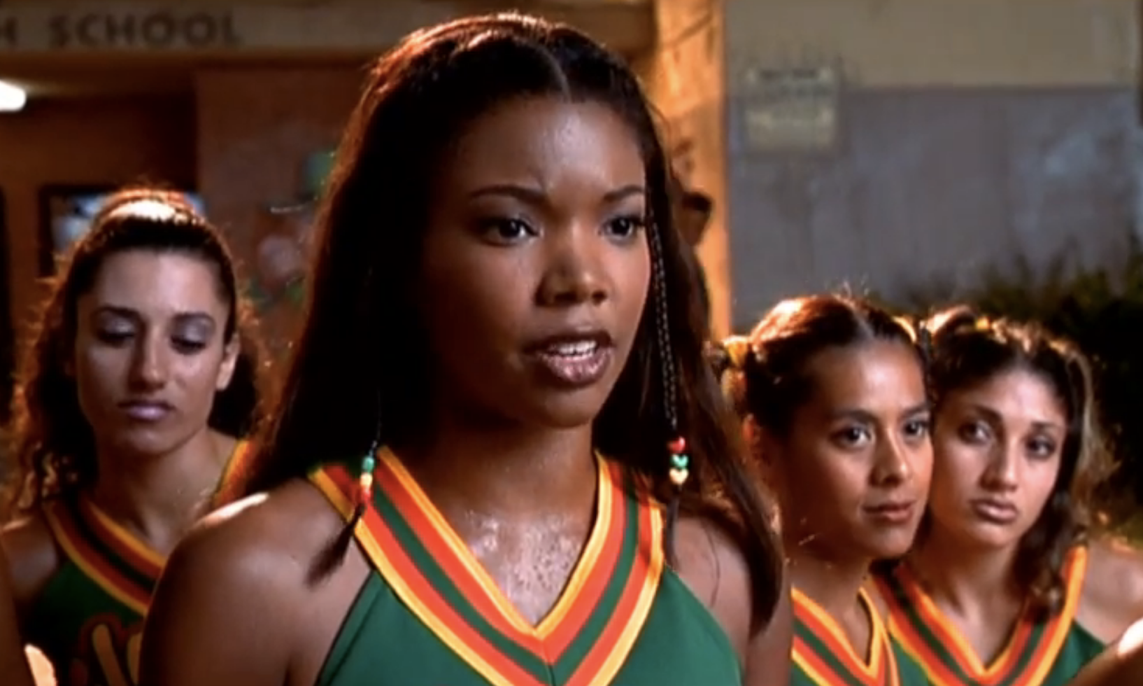 A scene from a movie showing Gabrielle Union as the character Isis with her cheerleading squad in the background